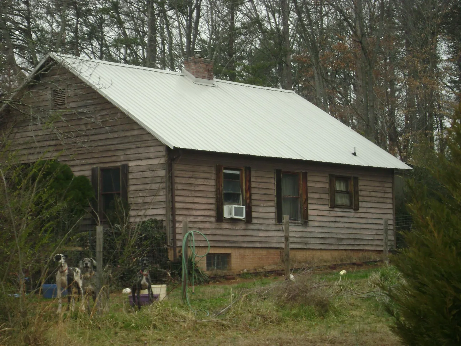 White metal roof on an old wood sided farmhouse, from a Metal Roof Installation job in Eagle Point